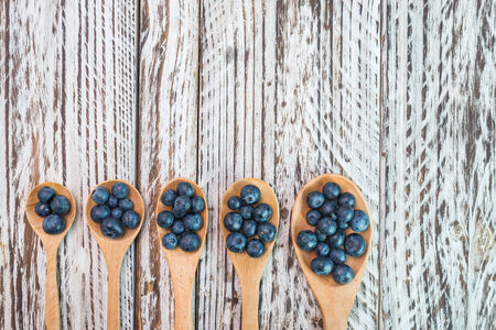 Blueberry spoon on wooden backgroundの写真素材