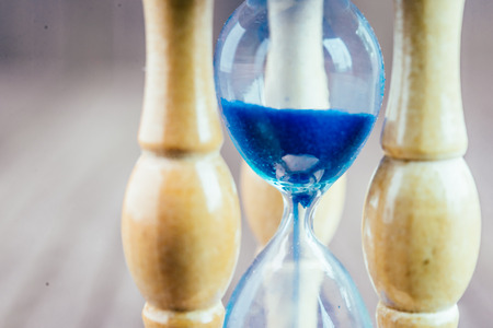 Hour glass on wooden background - vintage effect style pictures