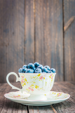 Blueberry cup on wooden background - vintage effect style picturesの写真素材
