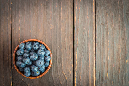 Blueberry bowl on wooden background - vintage effect style picturesの写真素材