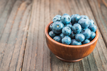 Blueberry bowl on wooden background - vintage effect style picturesの写真素材