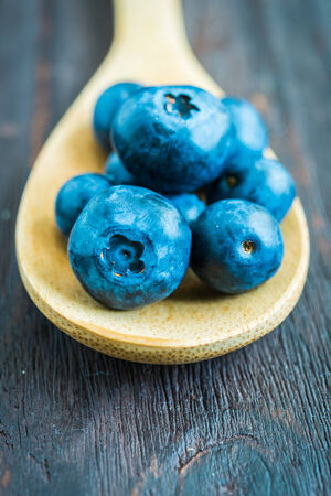 Blueberry spoon on wooden background - vintage effect style picturesの写真素材