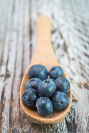 Blueberry spoon on wooden backgroundの写真素材