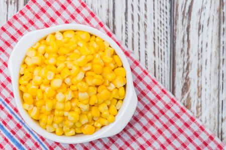 Sweet corn bowl on wooden backgroundの写真素材