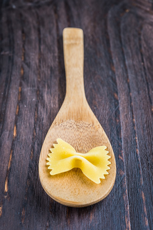 Raw pasta on wooden background - process old dark style pictureの写真素材