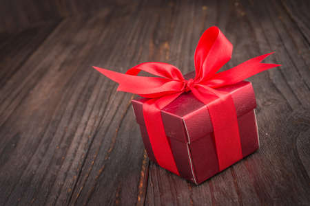 Gift box on wooden background - vintage old effect style picturesの写真素材