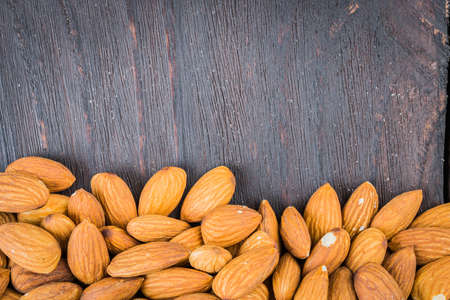 Almond on wooden background - vintage old effect stlye picturesの写真素材