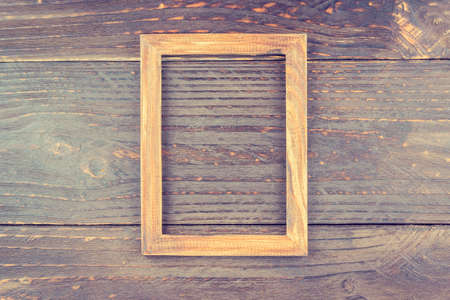 Photo frame on wooden background - vintage style effect pictureの写真素材