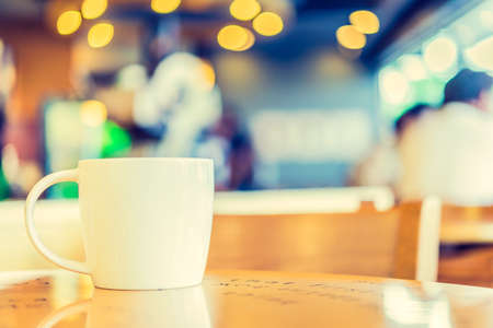 Coffee cup in coffee shop - vintage style effect pictureの写真素材