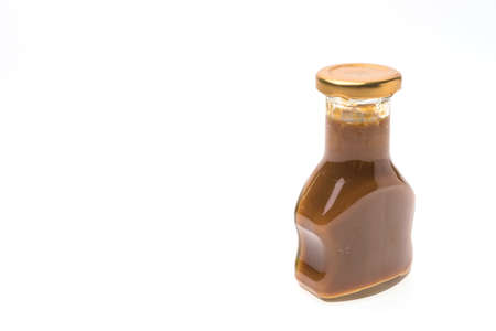 Caramel bottles sauce isolated on white backgroundの写真素材