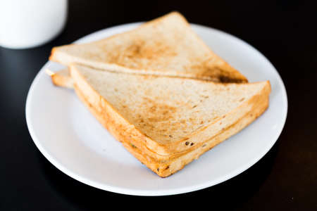 Tuna Sandwich in white plate on black table