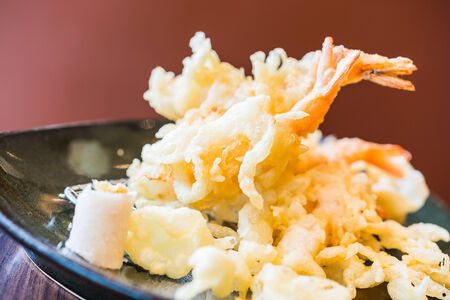 Tempur prawn - fried shrimp japanese style in black plate on wooden tablesの写真素材