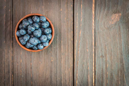 Blueberry bowl on wooden background - vintage effect style picturesの写真素材