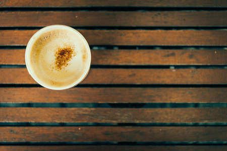 Top view of coffee cup on wooden table - vintage effect style picturesの写真素材