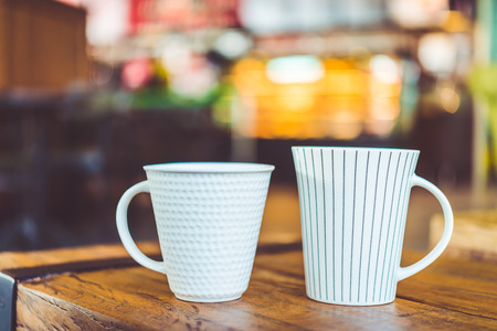 Hot latte Coffee cup on wooden table in coffee shop - vintage effect style pictures