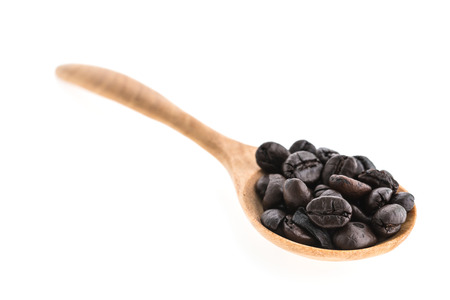 Coffee beans in wooden spoon isolated on white backgroundの写真素材