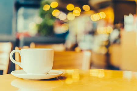 Black coffee in white cup on wooden table in coffee shop cafe - Vintage effect style picturesの写真素材