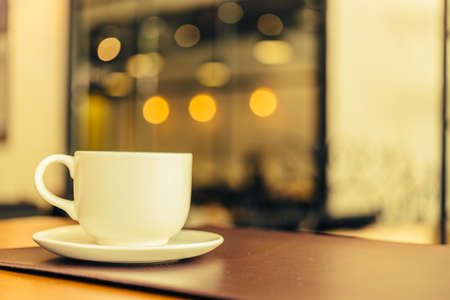 Black coffee in white cup on wooden table in coffee shop cafe - Vintage effect style picturesの写真素材