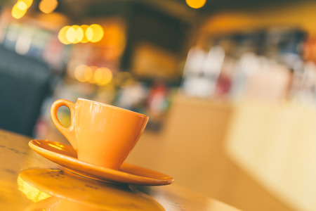 Black Coffee mug on wooden table in coffee shop - Vintage retro effect style picturesの写真素材