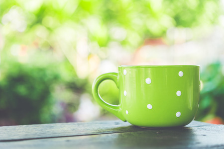 Coffee mug on wooden table - Vintage effect style picturesの写真素材