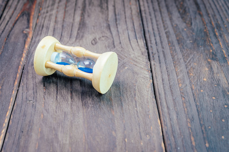 Hour glass on wooden background - vintage effect style picturesの写真素材