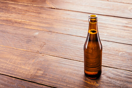 Beer bottle on wooden background - Vintage effect style picturesの写真素材