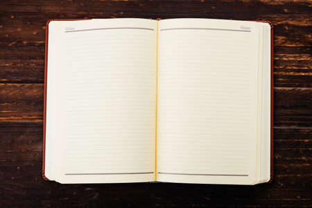 Note book on wooden background - Vintage effect style picturesの写真素材