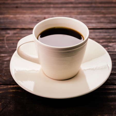 Coffee cup on wooden background - Vintage effect style picturesの写真素材