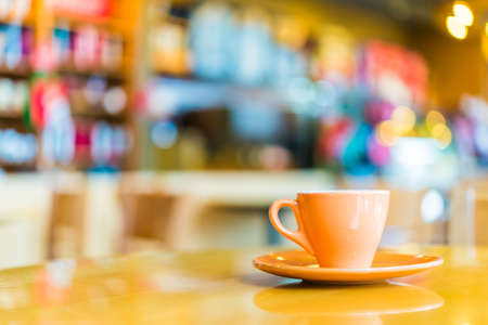Coffee cup on wooden table in coffee shop - vintage effect style picturesの写真素材
