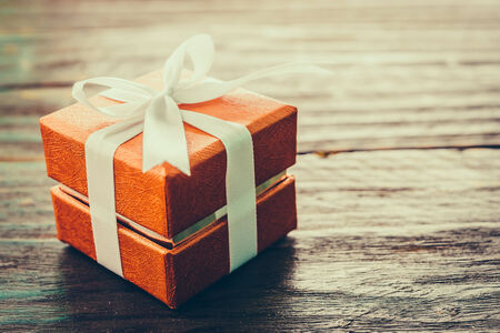 Gift box on wood background - vintage effect style pictures