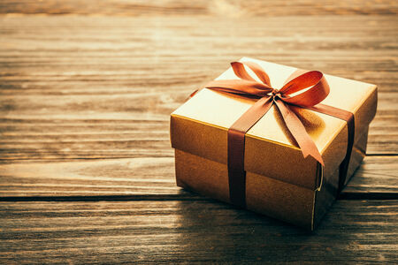 Gift box on wood background - vintage effect style pictures