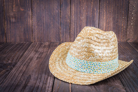 Beach hat on wooden background - vintage dark style picturesの写真素材