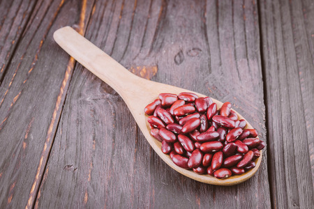 red beans in wooden spoon on woodenの写真素材