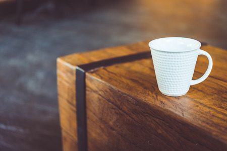 Hot latte Coffee cup on wooden table in coffee shop - vintage effect style picturesの写真素材