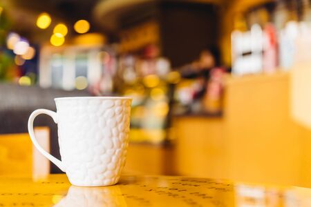 Coffee cup in coffee shop on wooden table - Vintage effect style picturesの写真素材