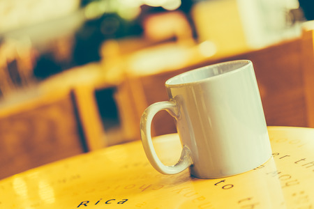 Coffee cup on wooden table in coffee shop cafe - Vintage effect style picturesの写真素材