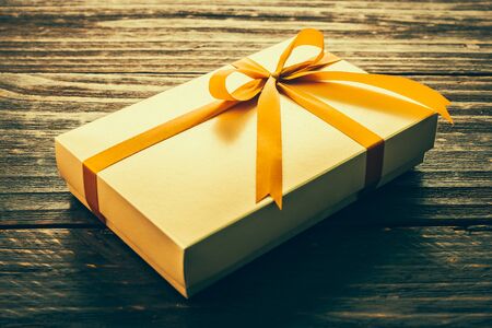 Gift box on wood background - vintage effect style picturesの写真素材