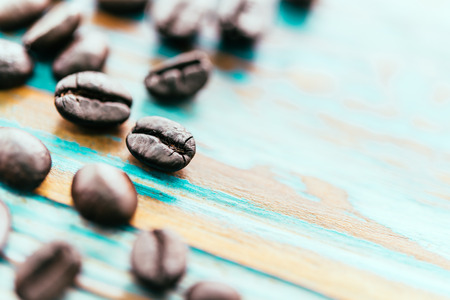 Coffee beans on wooden table - vintage effect