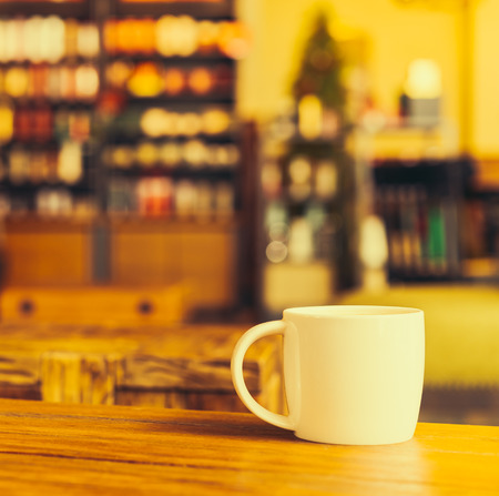 Latte coffee cup on table in coffee shop - Vintage old effect processing picture styleの写真素材