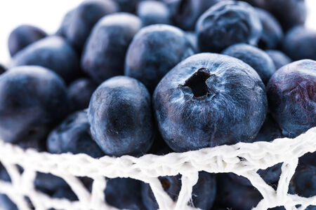 Blueberry basket isolated on whiteの写真素材