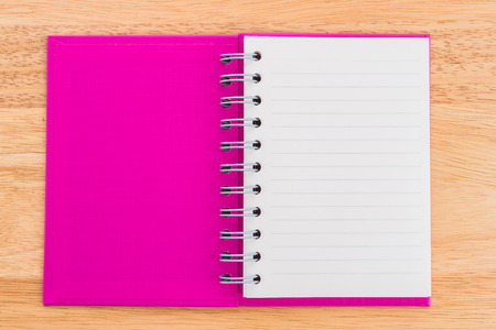 Note book on wood backgroundの写真素材