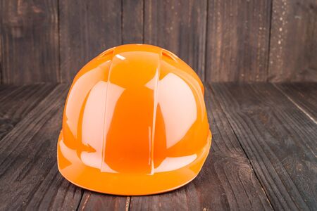 Construction hard hat on wooden backgroundの写真素材