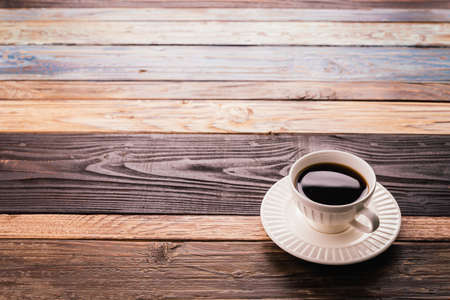 Coffee cup on wooden background - vintage effect picturesの写真素材
