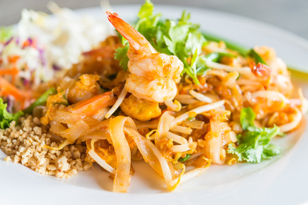 Pad thai noodles in white plate - thai foodの写真素材