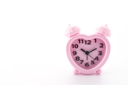 Pink alarm clock isolated on white backgroundの写真素材