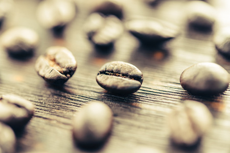 Coffee beans on wooden table - vintage effectの写真素材