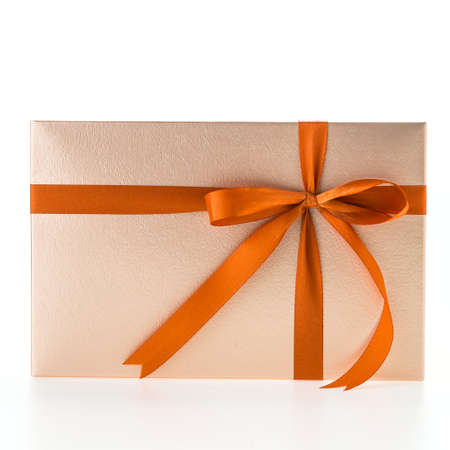 Christmas gold gift box isolated on white backgroundの写真素材