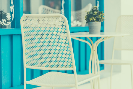 Selective focus point on Chair in coffee shop outdoor zone - vintage filter effectの写真素材