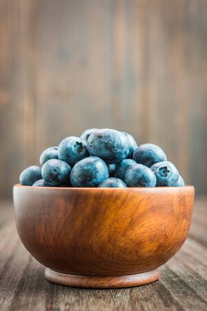 Blueberry bowl on wooden background - vintage effect style picturesの写真素材