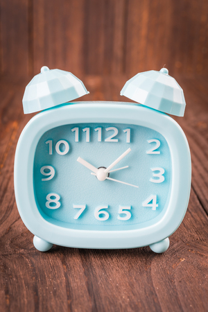 Clock on wood backgroundの写真素材